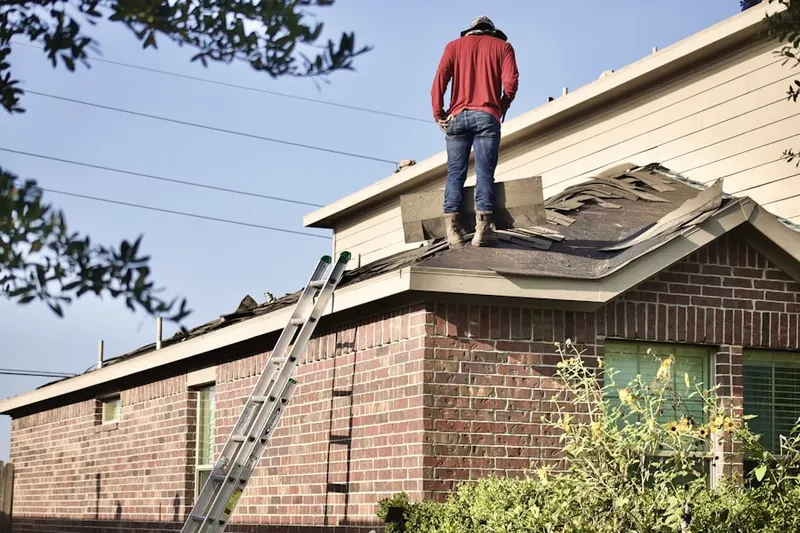 Professional roofer working on a residential roof in Renaissance Commons